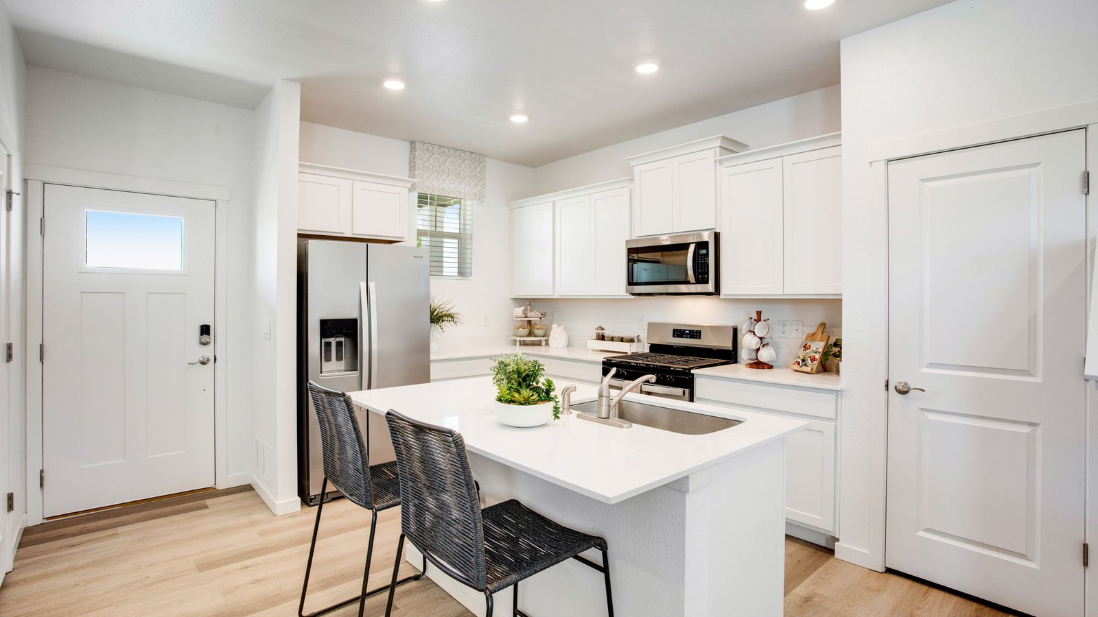 Modern kitchen in the Muirfield floor plan featuring a spacious island, sleek cabinetry, and an open-concept design.