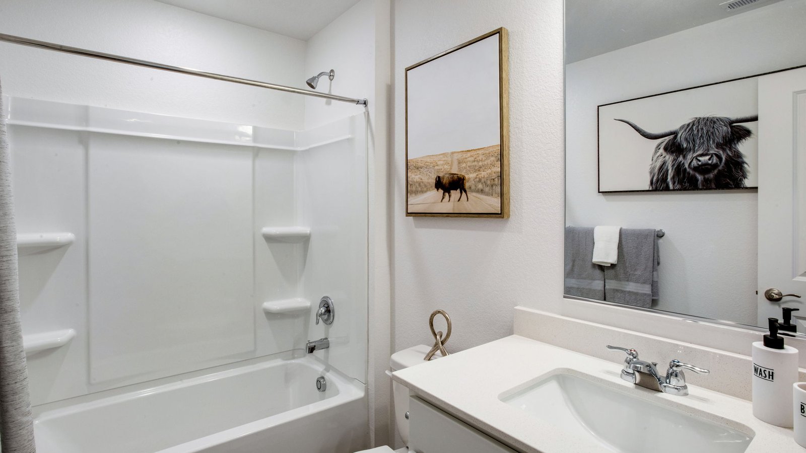 Full bathroom in the Muirfield floor plan featuring modern fixtures and a clean design.