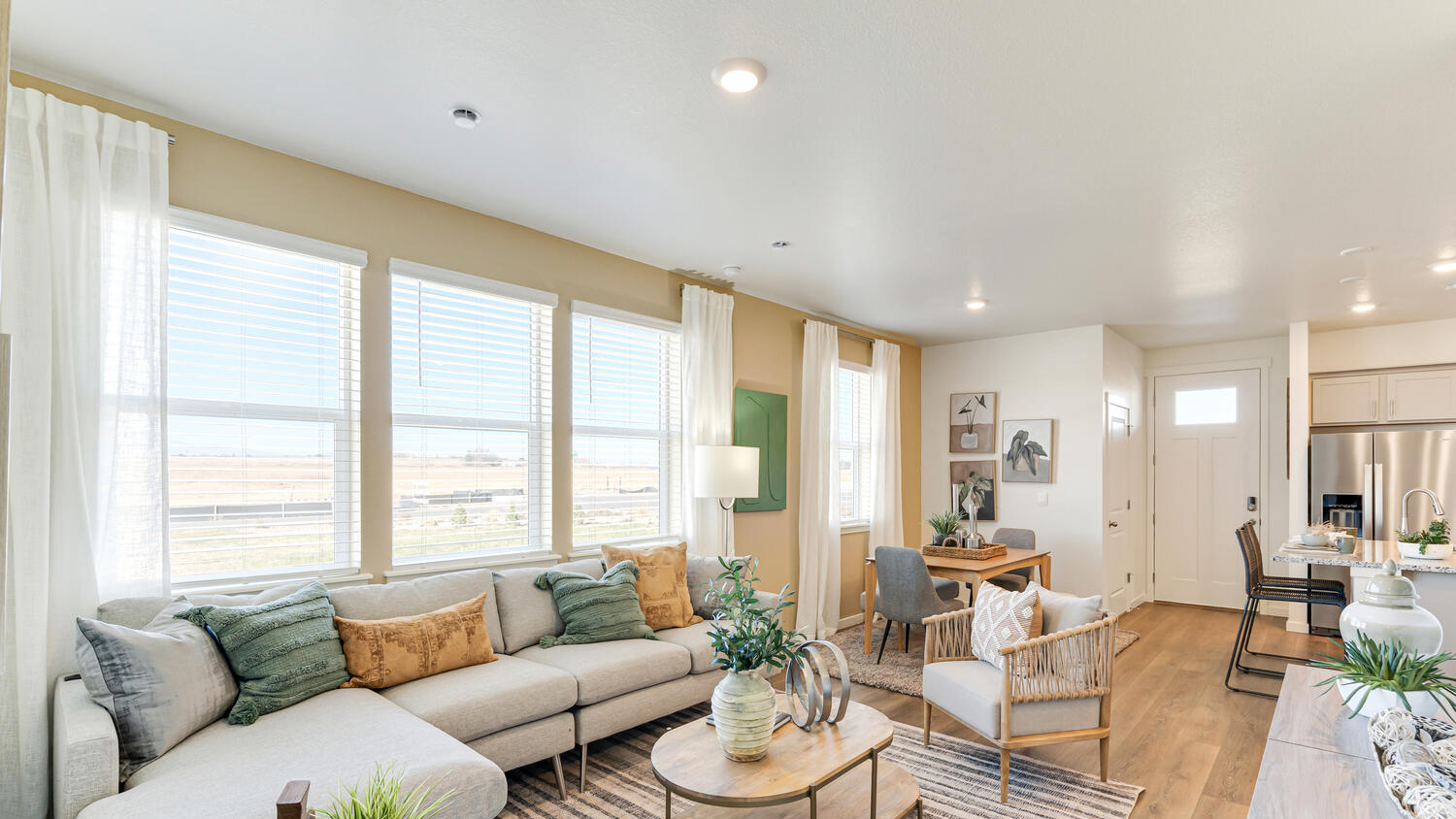 Bright open-concept living area in the Muirfield floor plan connected to the kitchen and dining space.