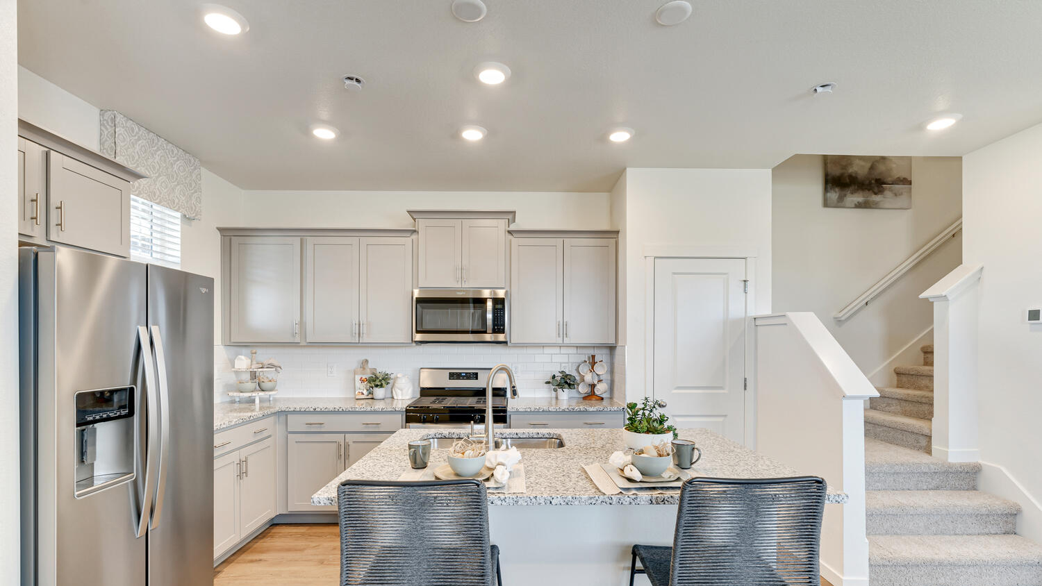 Modern kitchen in the Muirfield floor plan featuring a spacious island, sleek cabinetry, and an open-concept design.