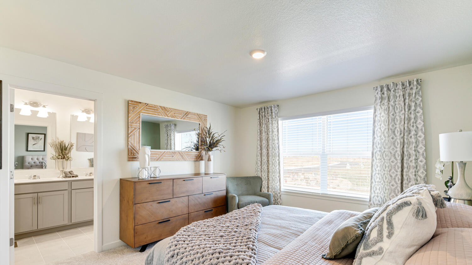 Relaxing primary bedroom in the Muirfield home designed as a comfortable retreat.
