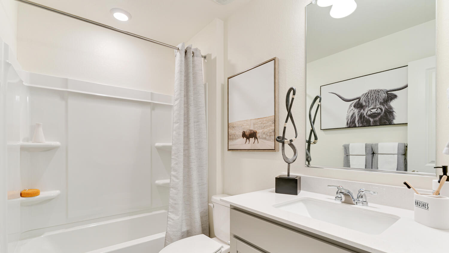 Full bathroom in the Muirfield floor plan featuring modern fixtures and a clean design.