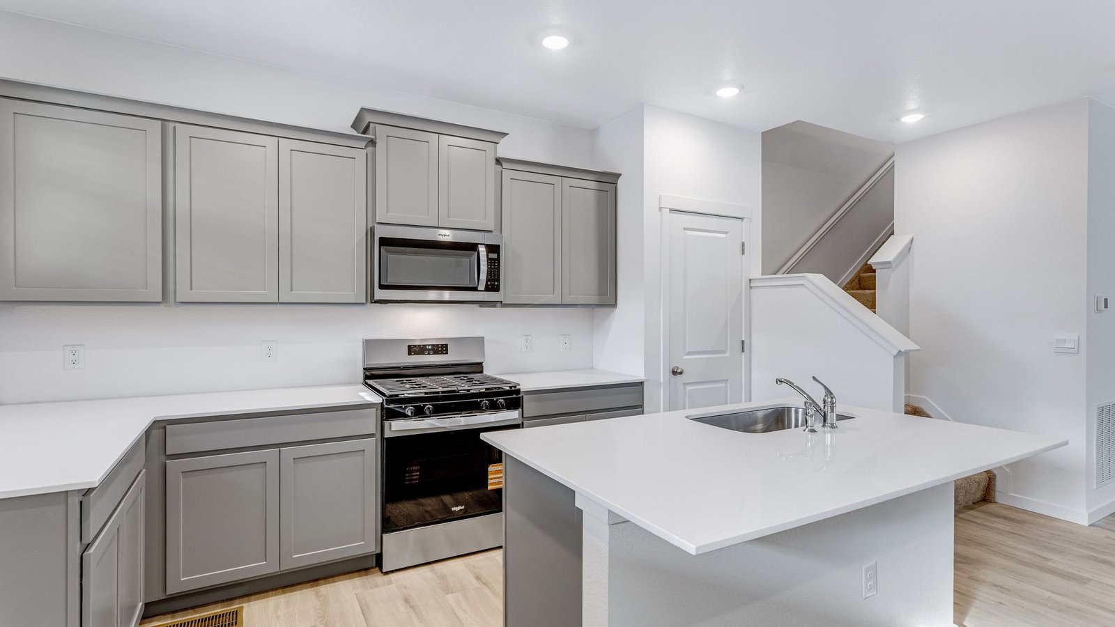 kitchen with gray cabinets in paired home johnstown, co