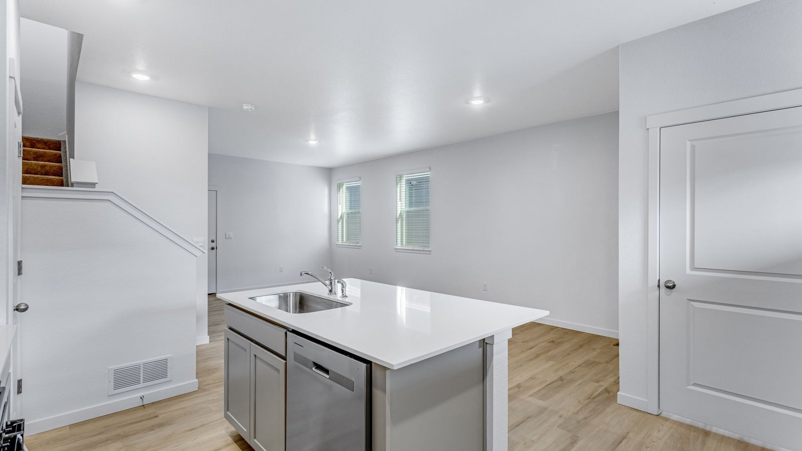 view of dining and living room from kitchen in new construction home johnstown, co