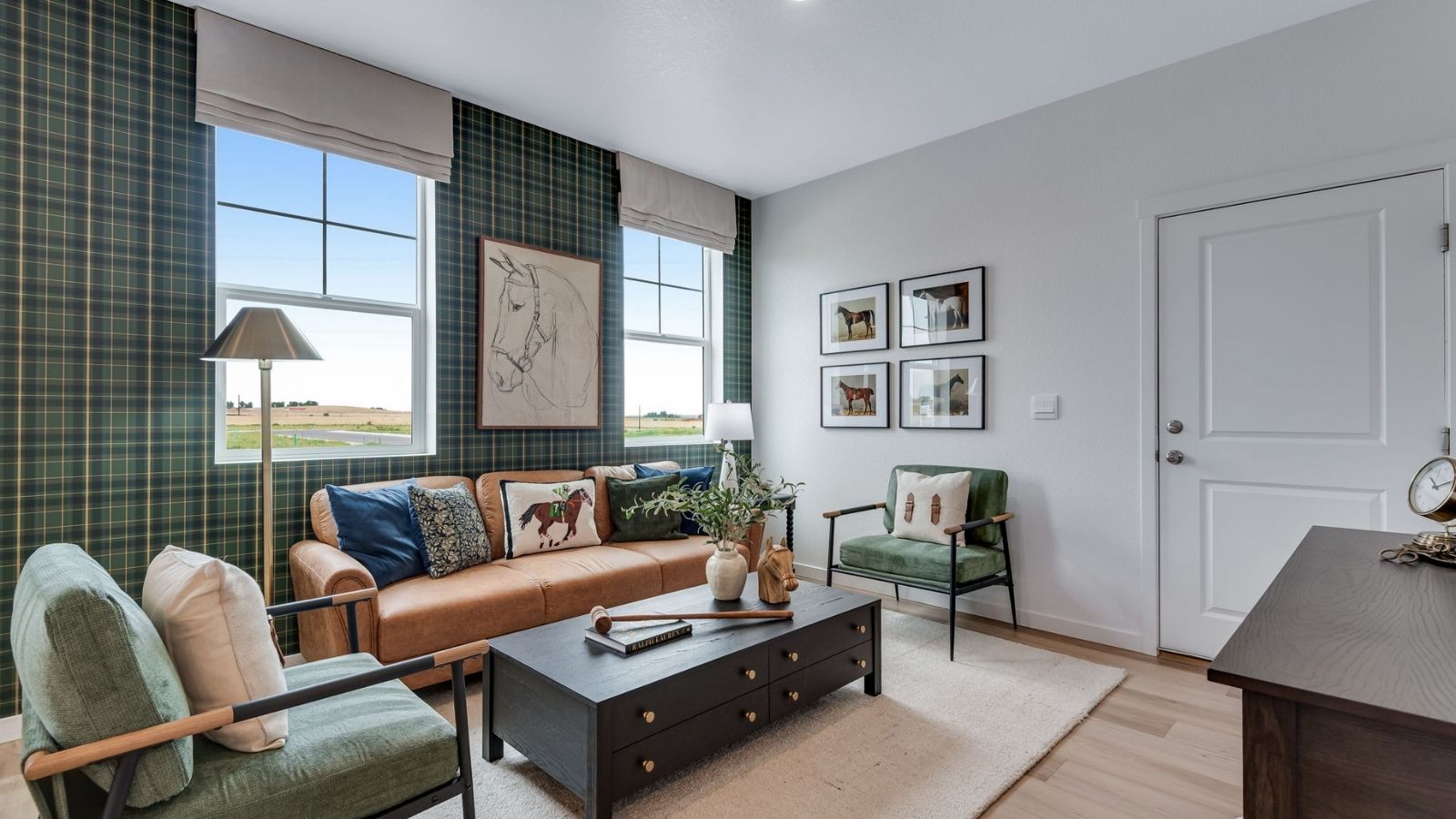 Living room with plaid wallpaper in new paired home in Revere at Johnstown by D.R. Horton