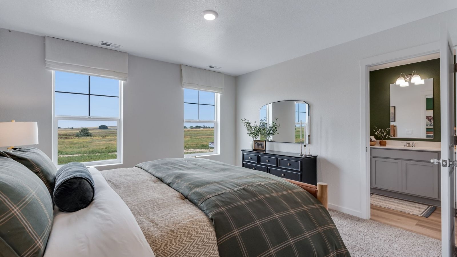 Bright and airy primary bedroom in new D.R. Horton home in Revere at Johnstown by D.R. Horton