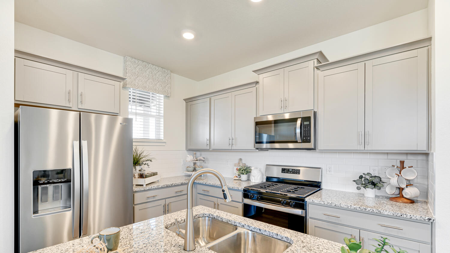 Modern kitchen in model home at Revere at Johnstown community by D.R. Horton in Johnstown, CO
