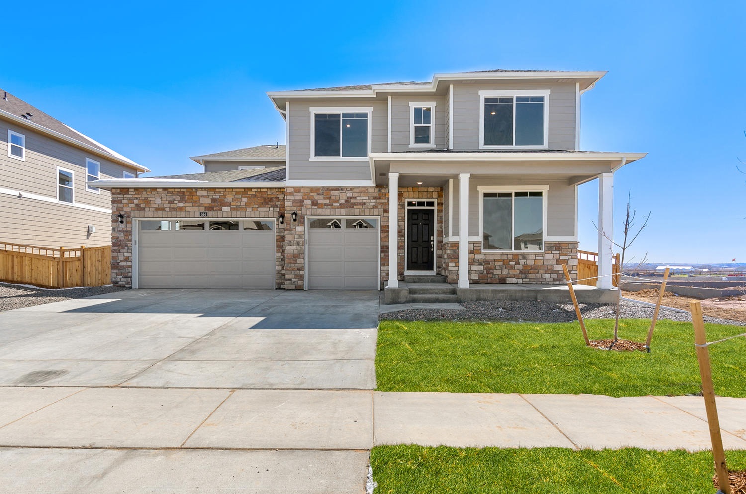 Arvada floorplan with two car garage interior photo with front yard landscaping