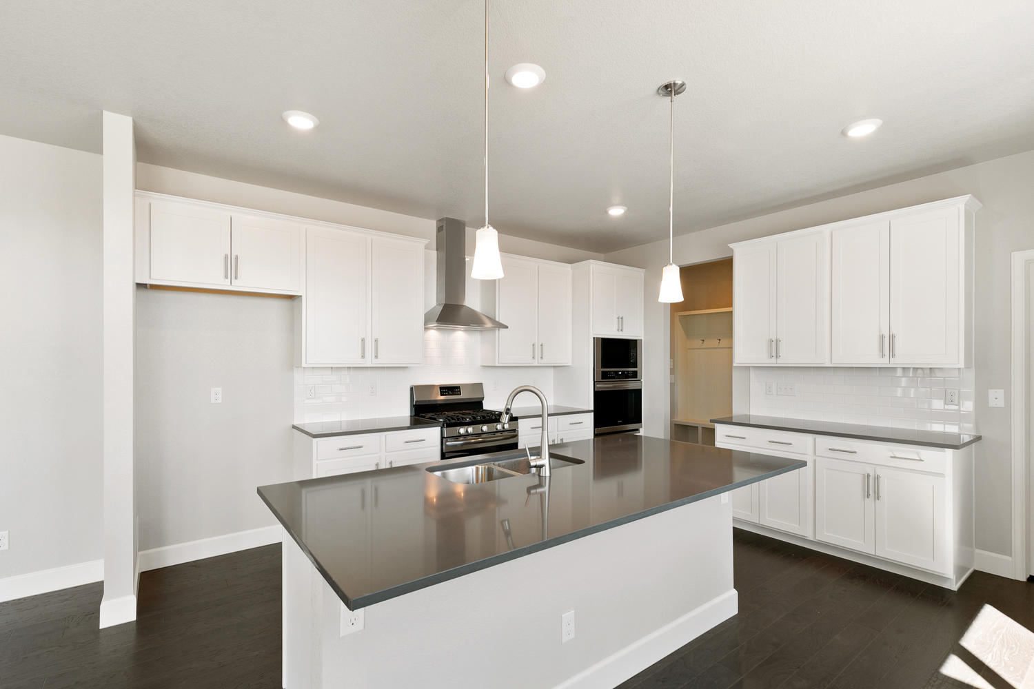white cabinet kitchen with an island