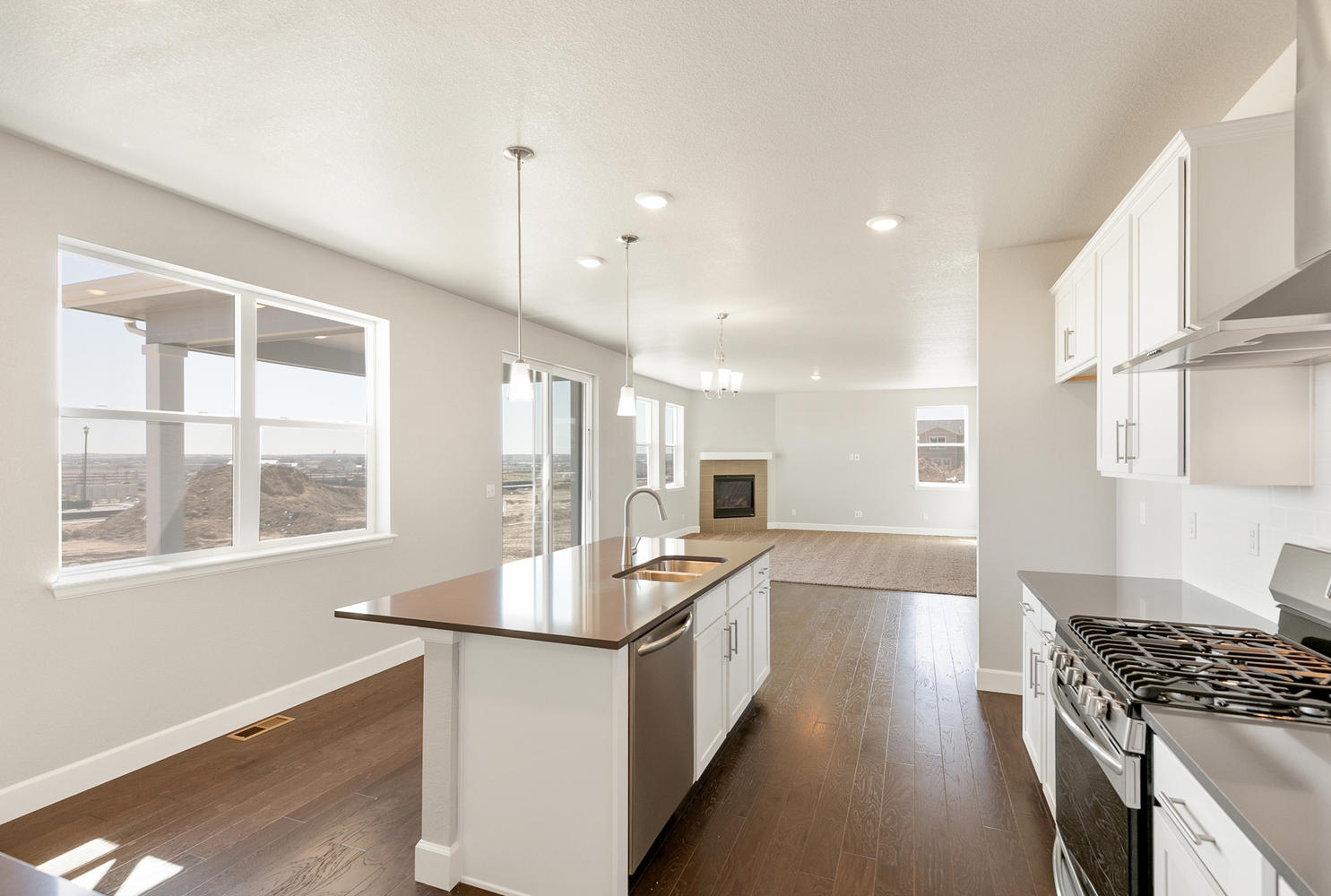 open space kitchen with window and wood floor