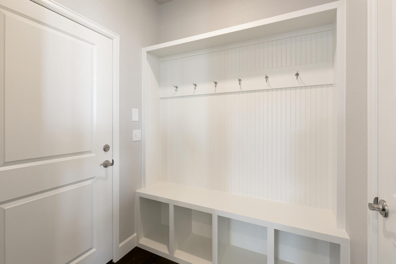 dusty room with door racks and coat racks