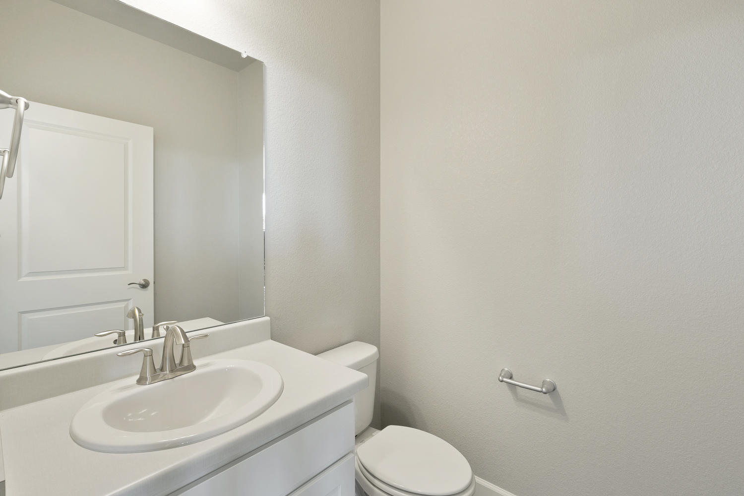 half bath with a mirrow, sink and toilet