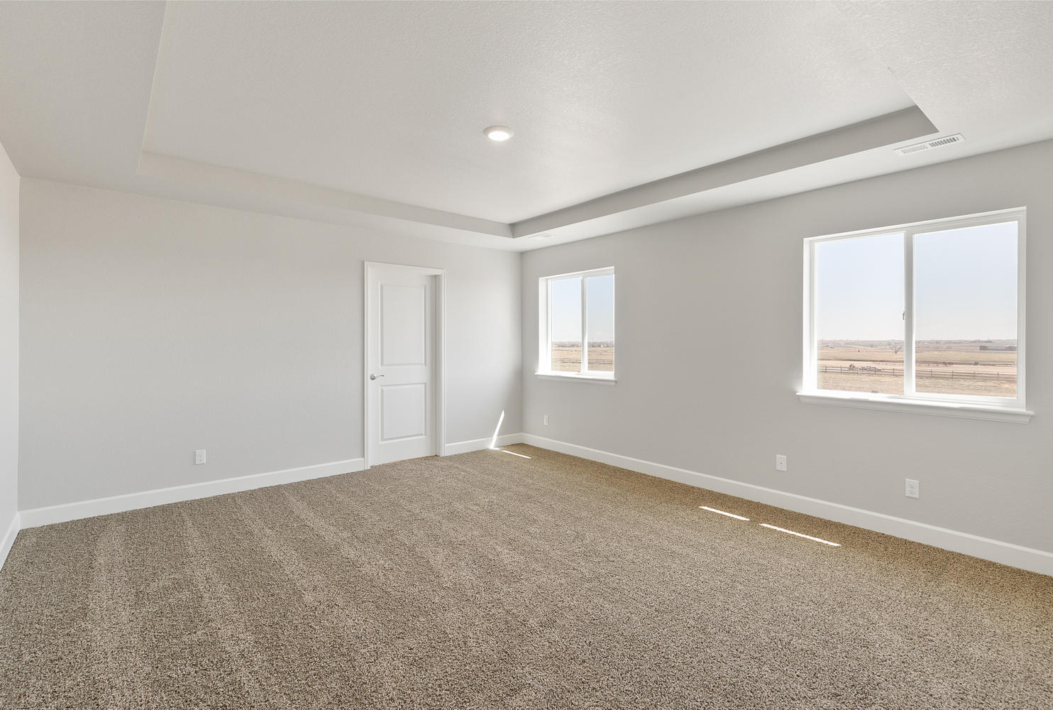 bedroom with two windows and carpet floor