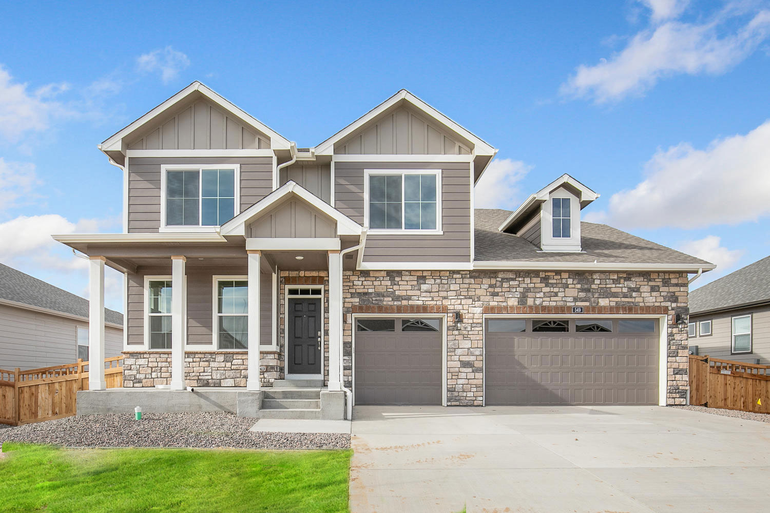 Branson floorplan with two car garage interior photo with front yard landscaping