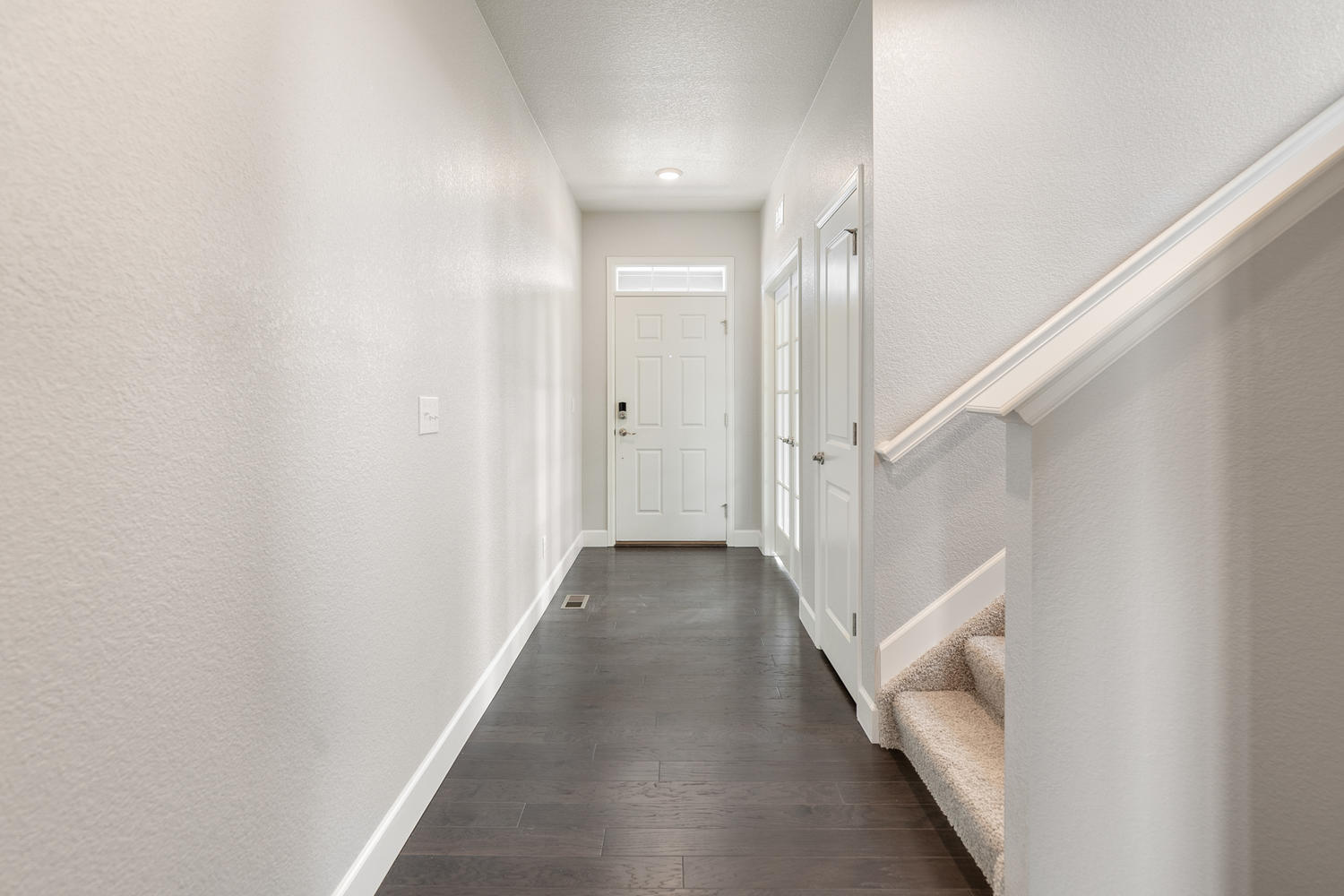 entry way view to front door and second floor stairs