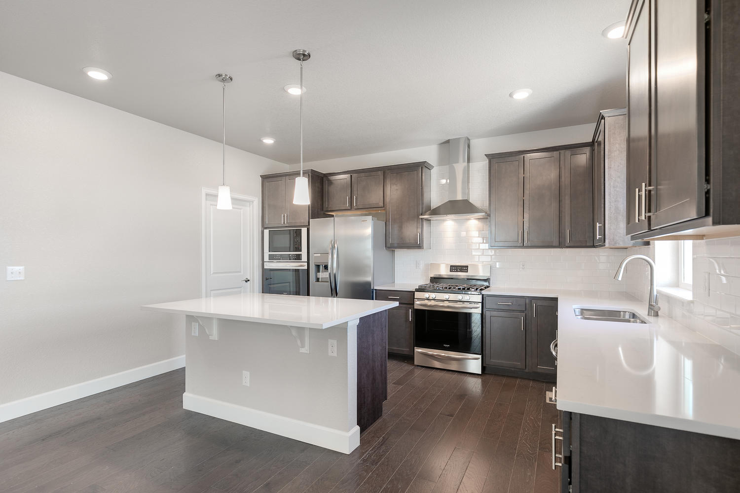 brown cabinet kitchen with an island  and stainless steel appliances