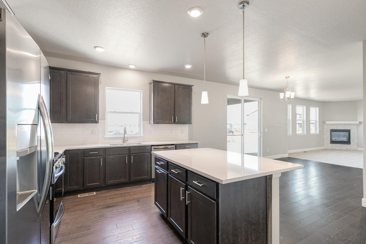 brown cabinet kitchen with an island  and stainless steel appliances