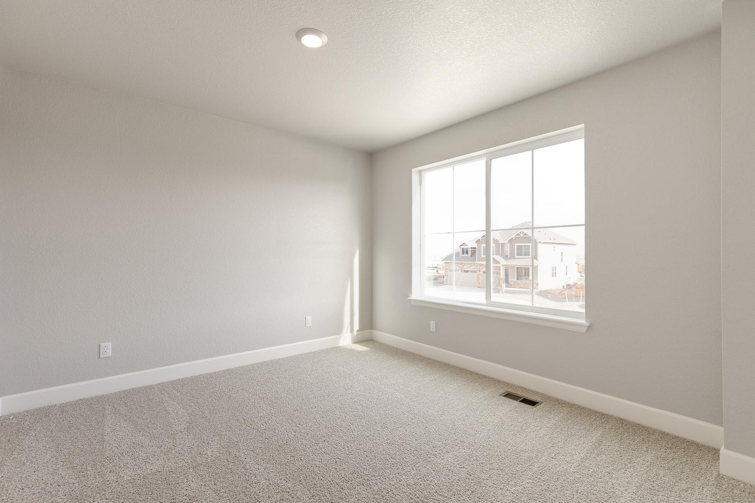 bedroom with a window and carpet floor