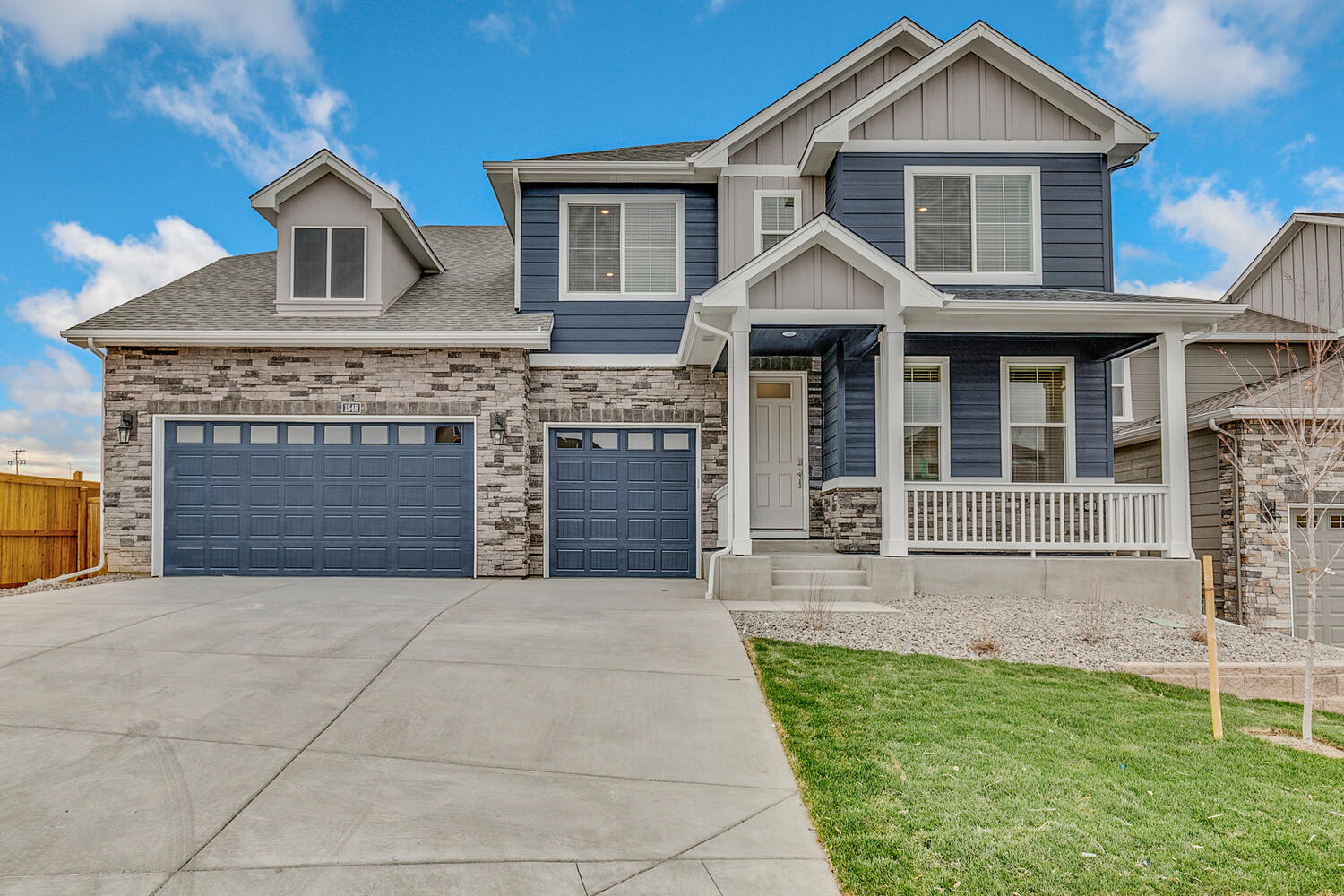 crawford floorplan with two car garage interior photo with front yard landscaping