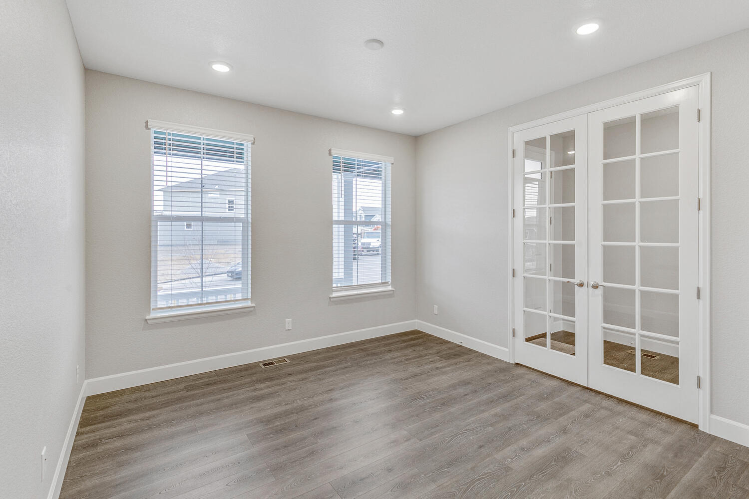 study with two windows and wood floor