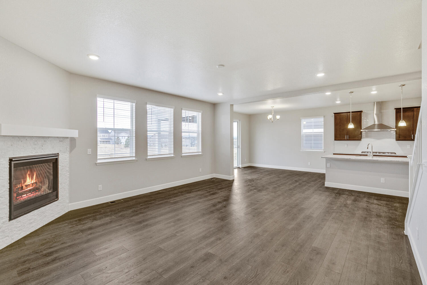 open space living room and kitchen with four windows