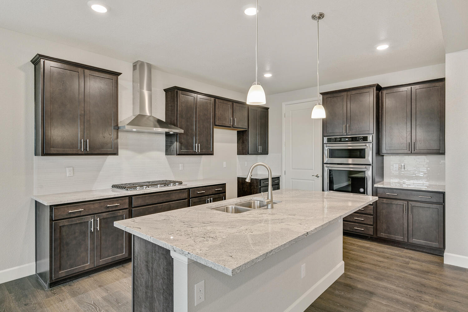 brown cabinet kitchen with an island and stainless steel appliances