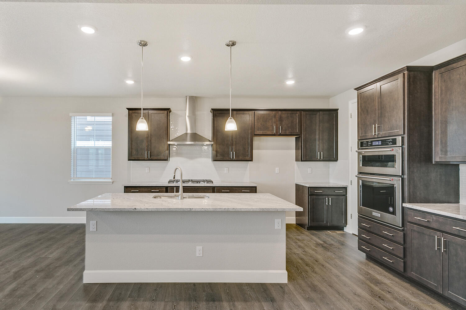 brown cabinet kitchen with an island and stainless steel appliances
