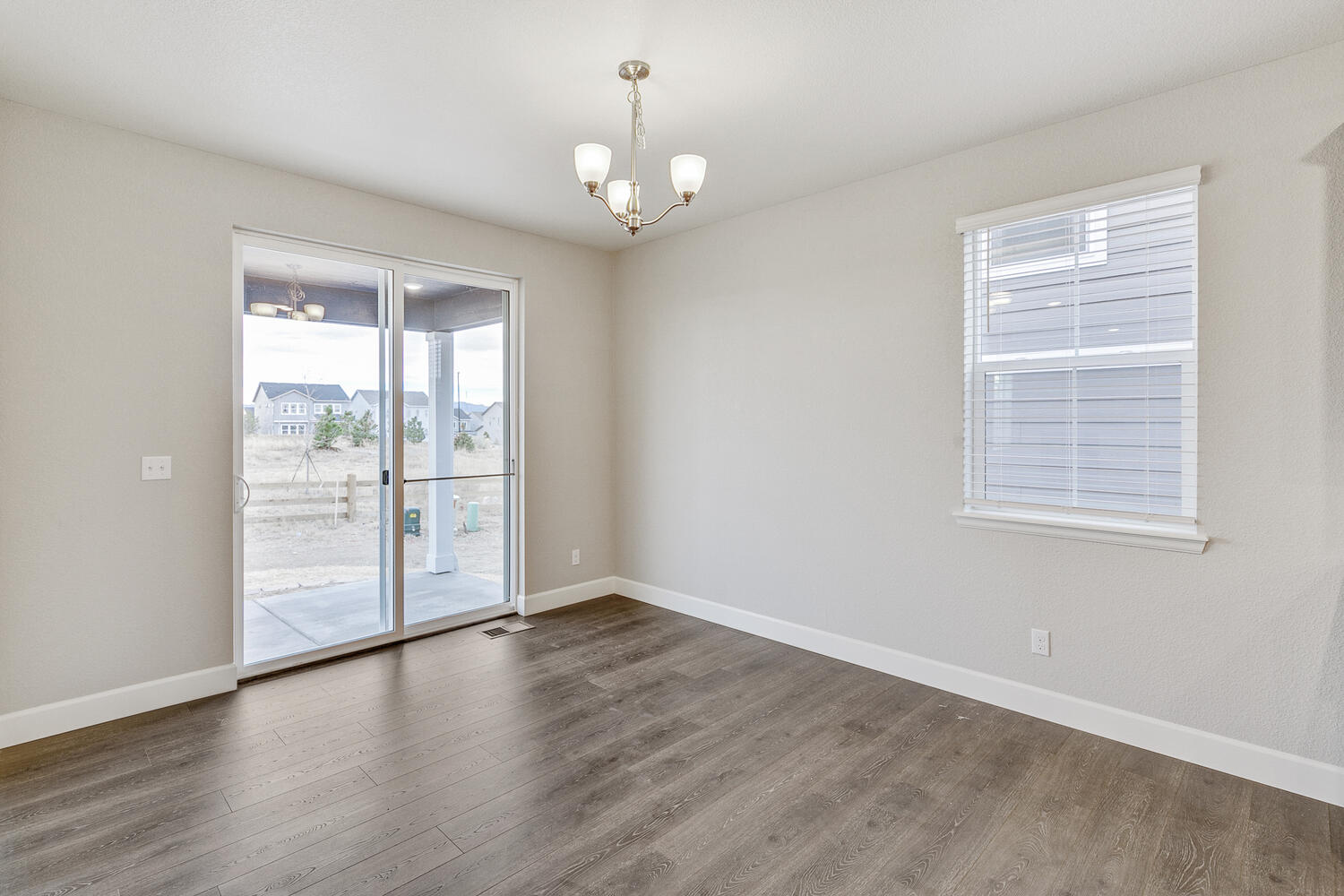 dining room with a back door, window and ceiling light
