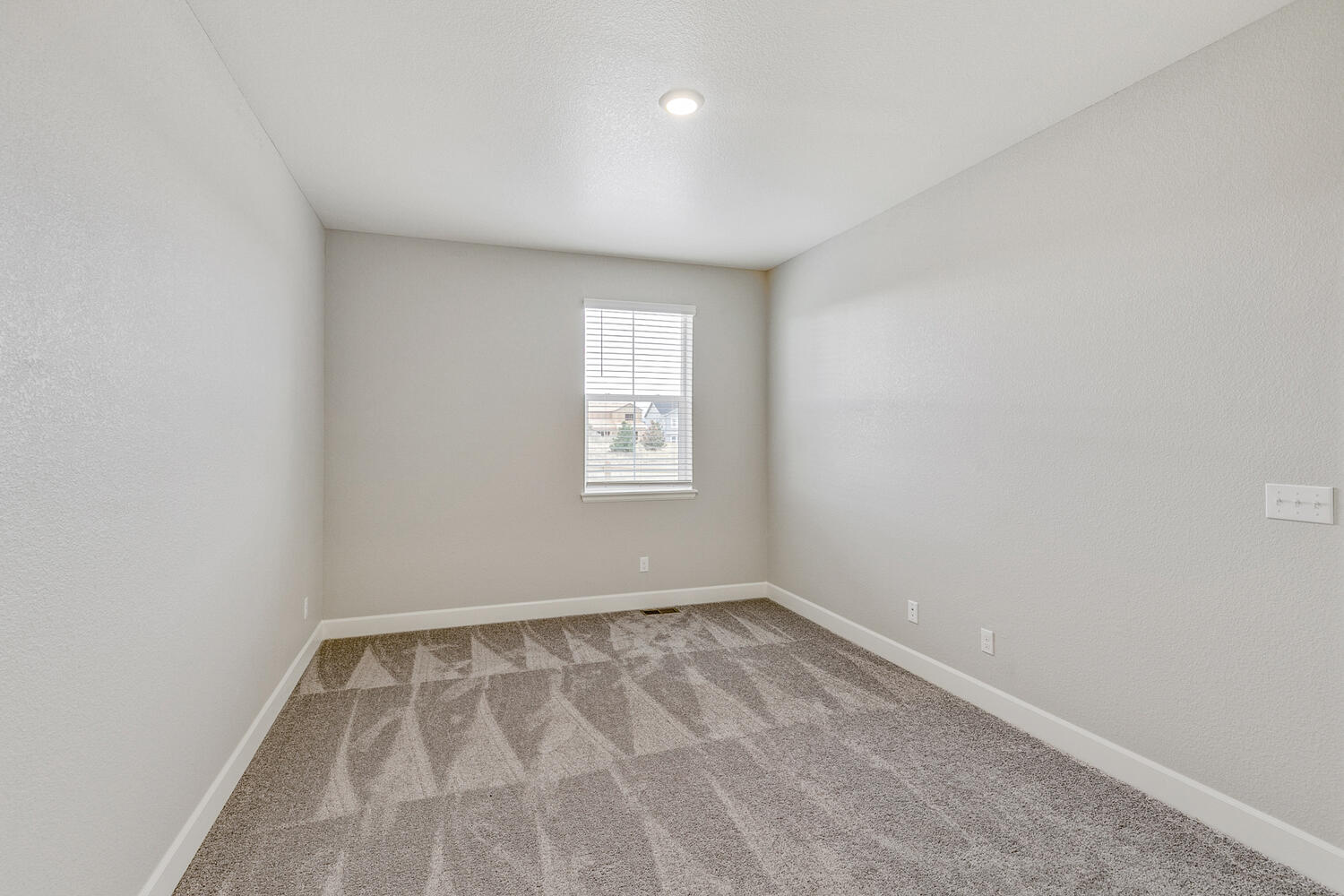 bedroom with a window and carpet floor