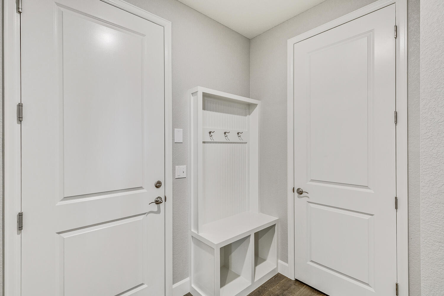 dusty room with shoes shelves and coat rack