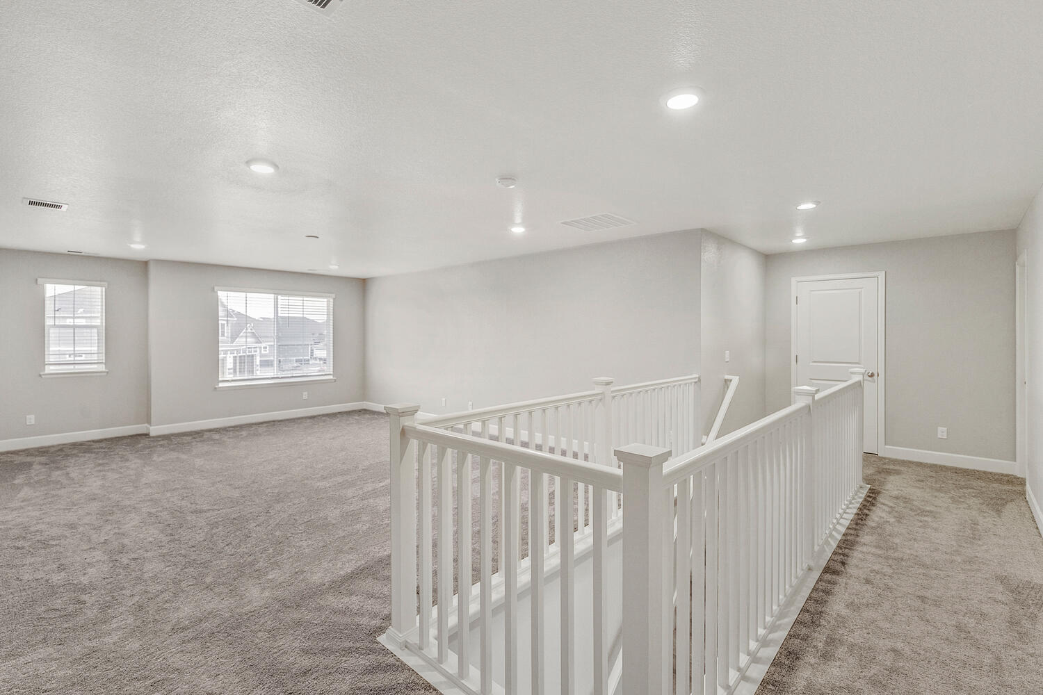 second floor loft with windows and two windows