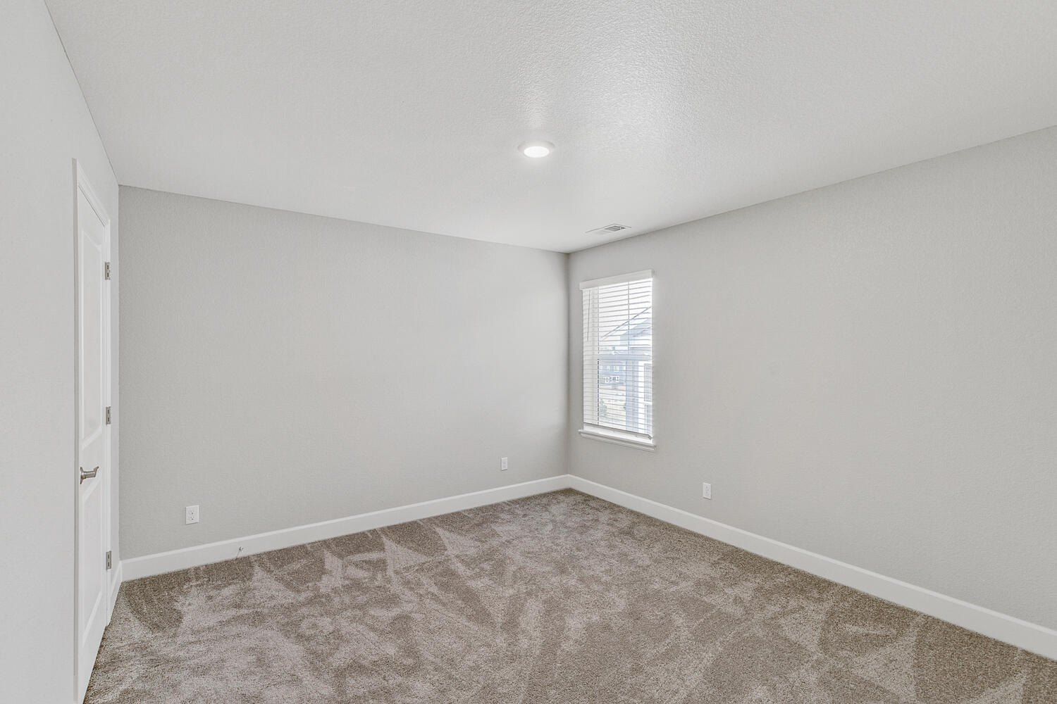 bedroom with a window and carpet floor