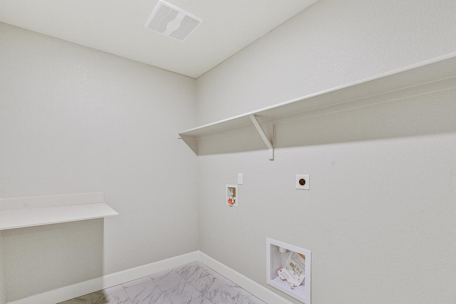 laundry room with washer and dryer hook up with shelves