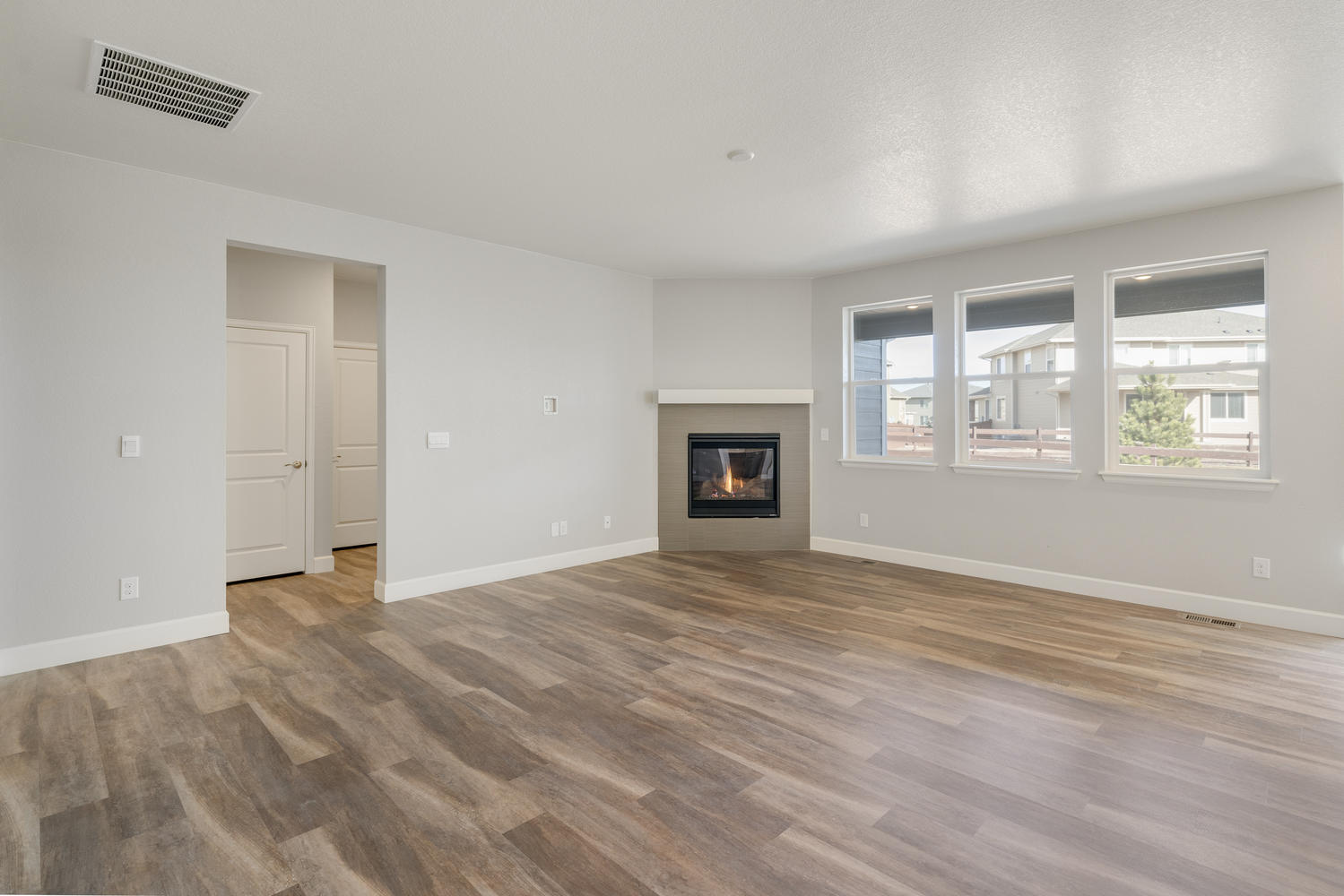 living room with a fireplace, carpet floor, and windows