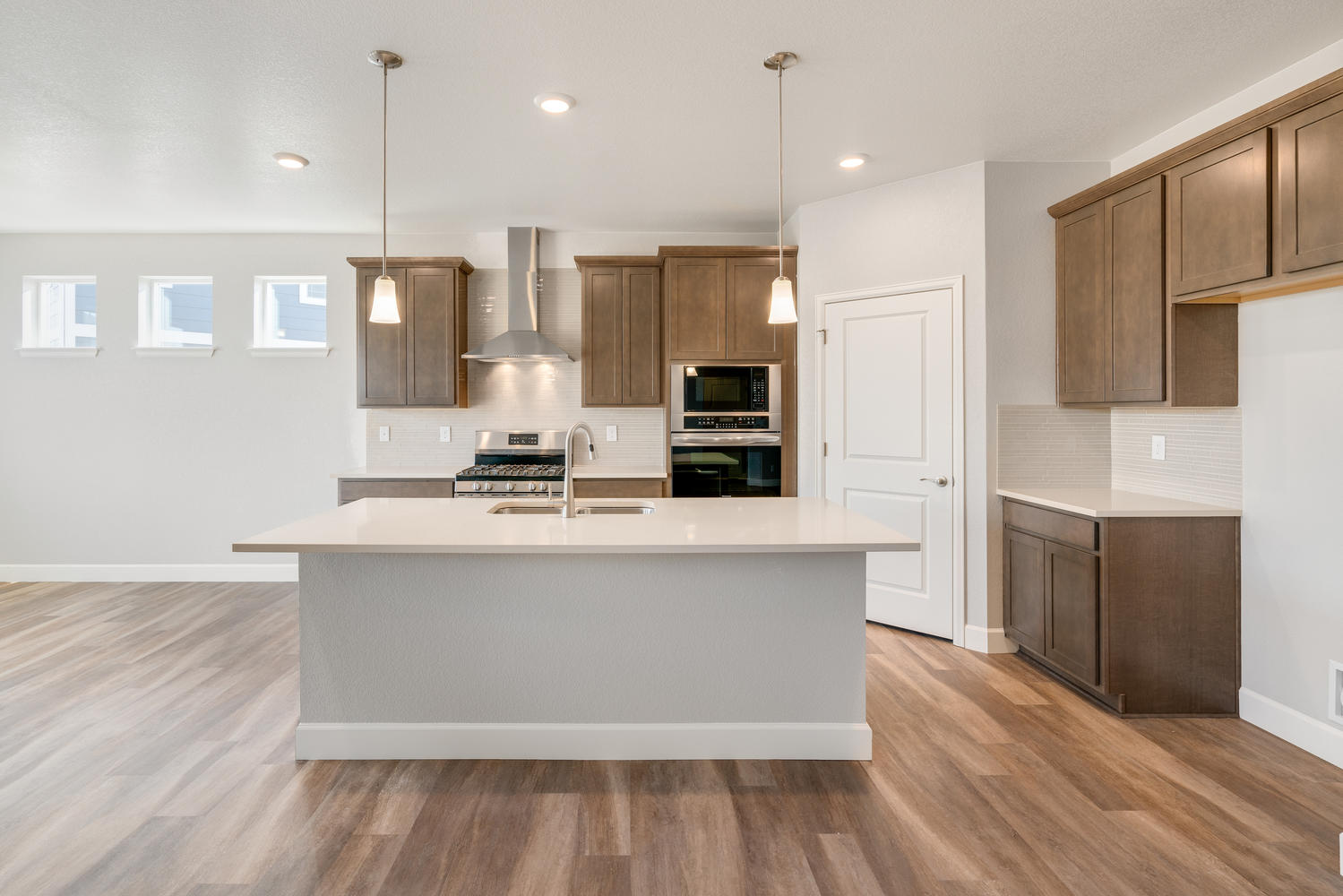 brown cabinet kitchen with stainless steel appliances, and an island
