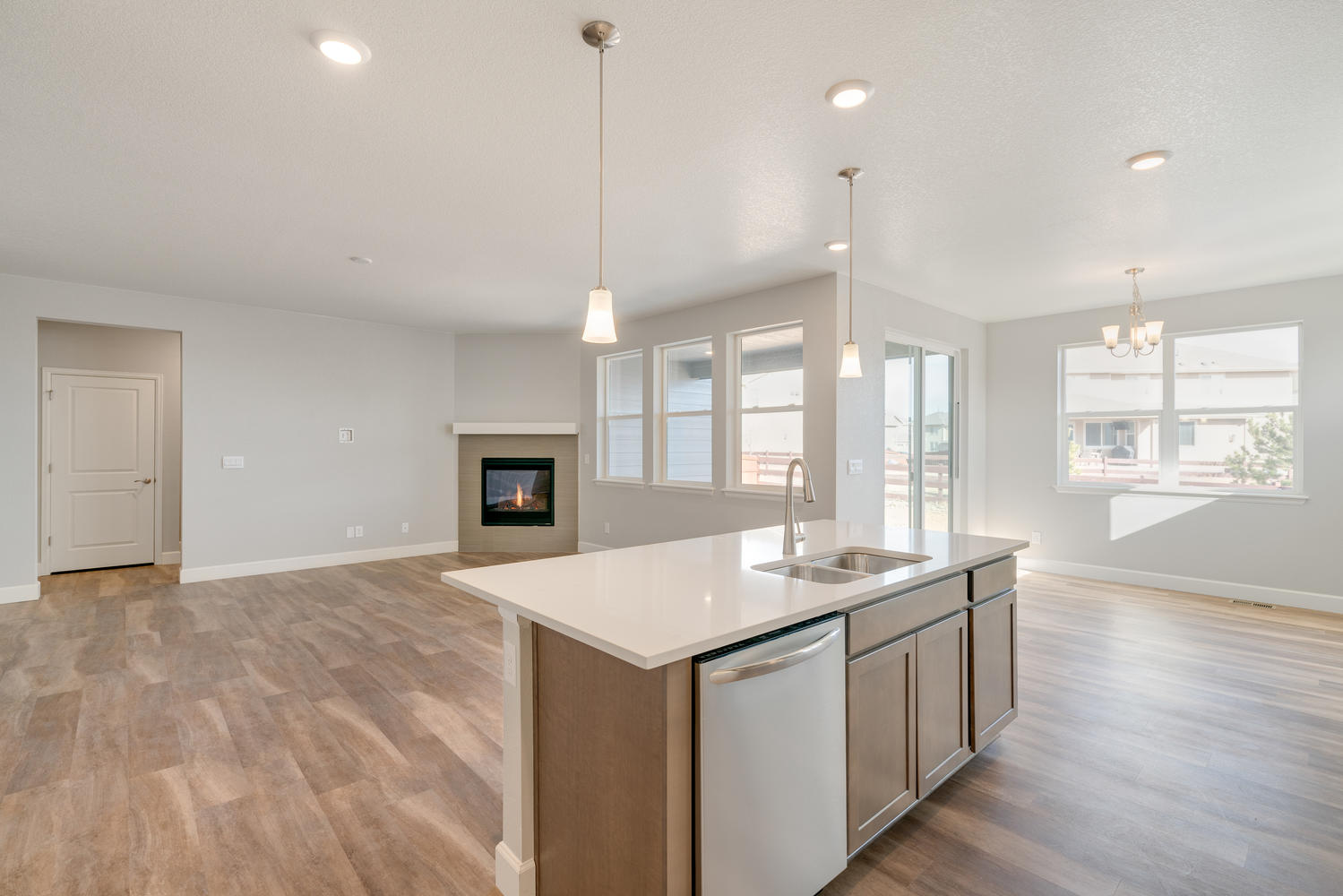 kitchen view of living room with a fireplace