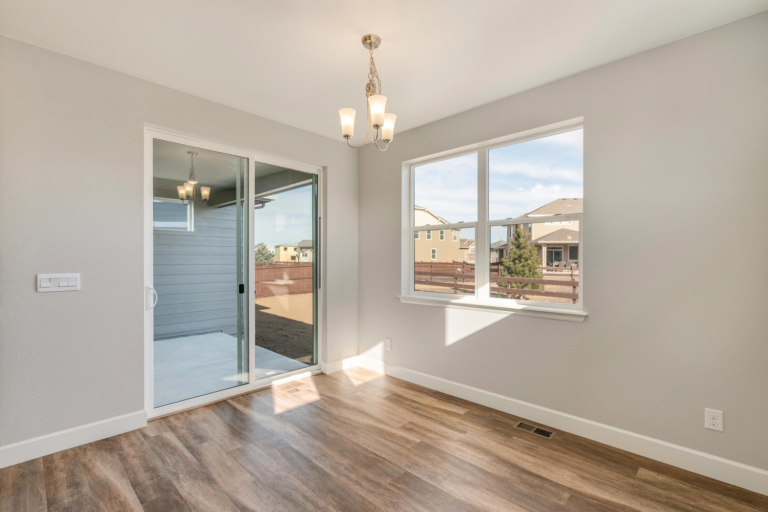 dining room with a back door, a window, ceiling light and wood floor
