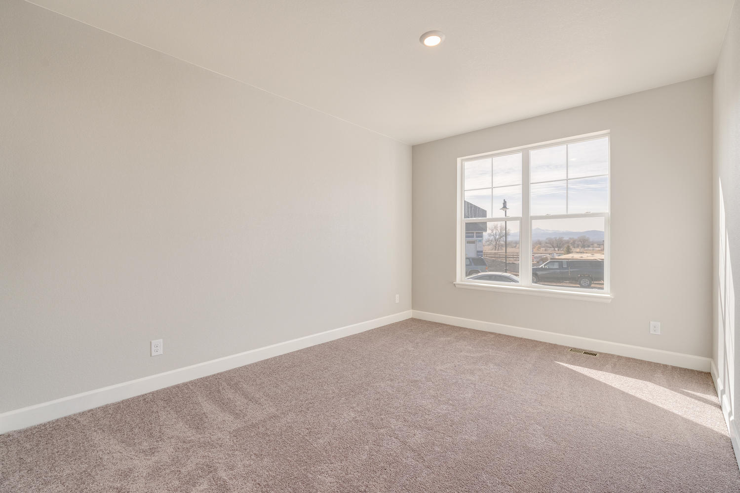 bedroom with a window and carpet floor