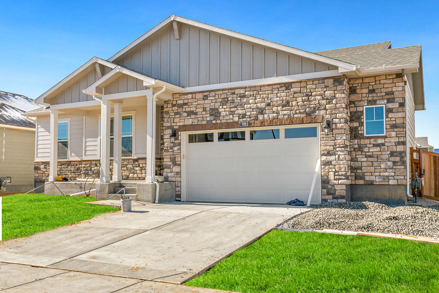 haswell floorplan exterior photo with two and half car garage and front yard landscaping