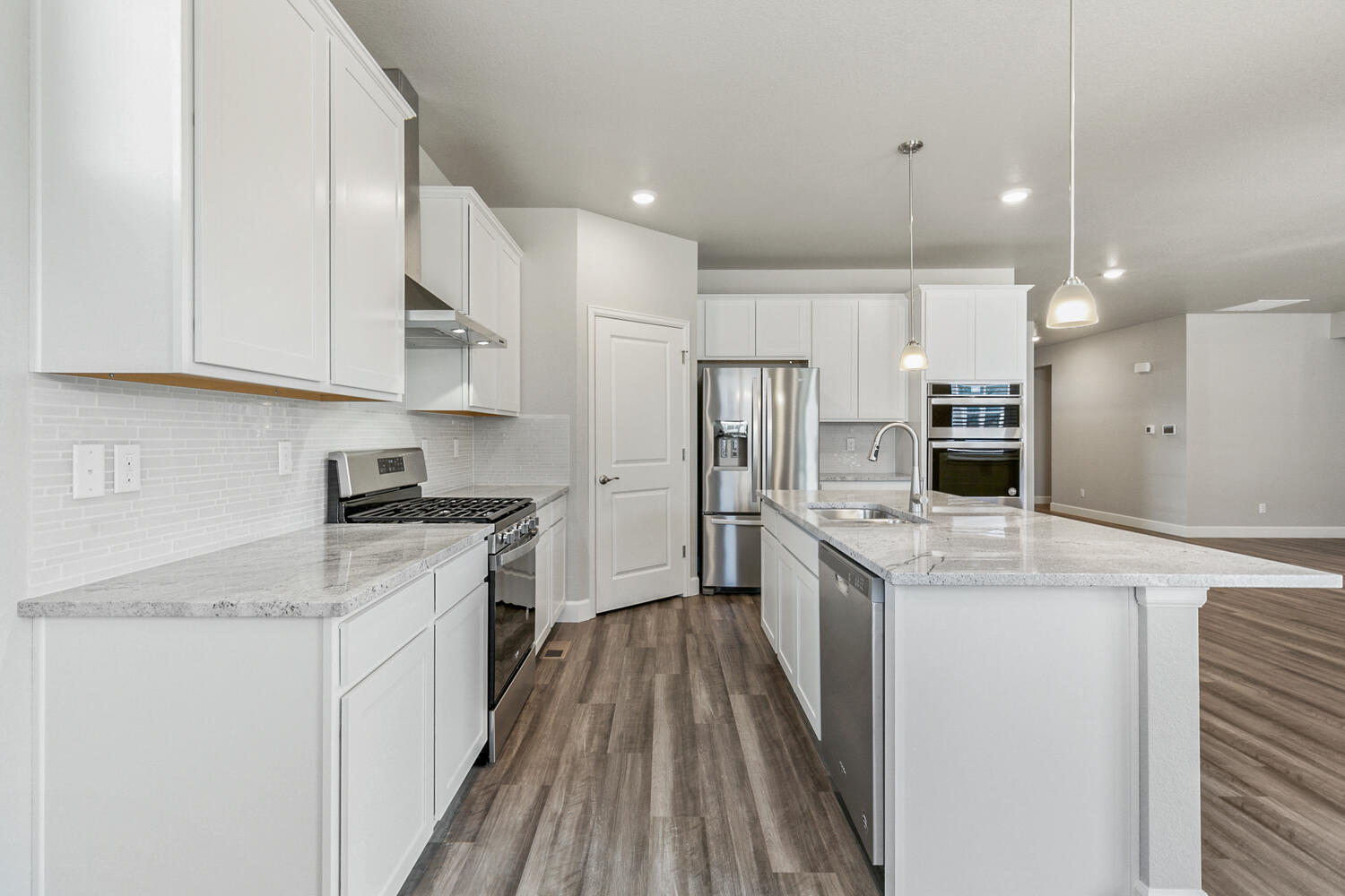 white cabinet kitchen with stainless steel appliances and an island
