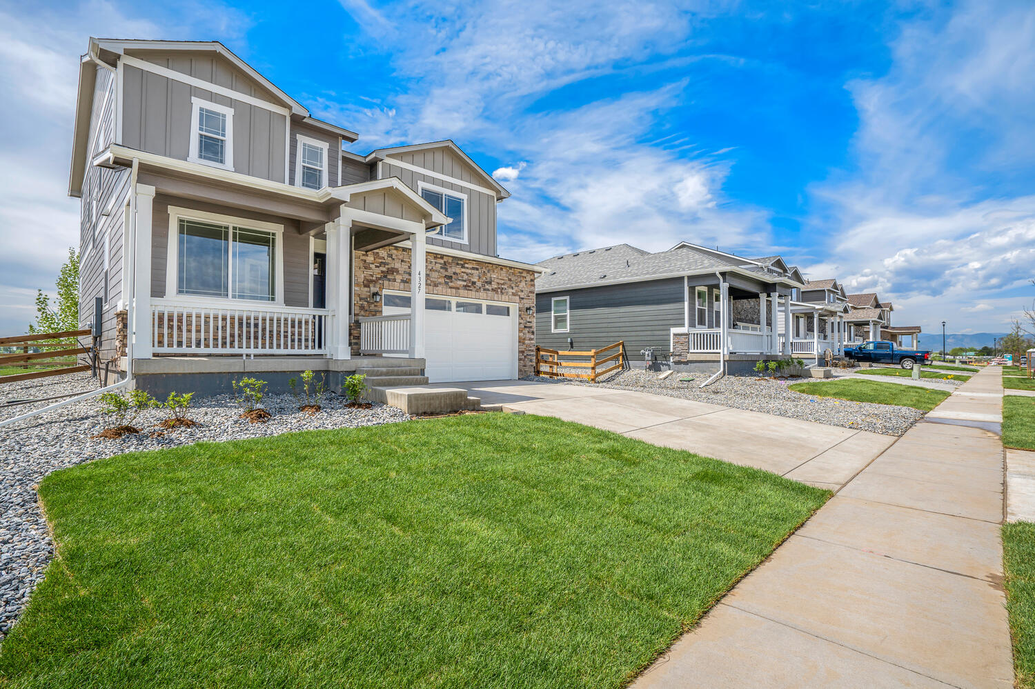 Bennett floorplan with two left side view car garage interior photo with front yard landscaping