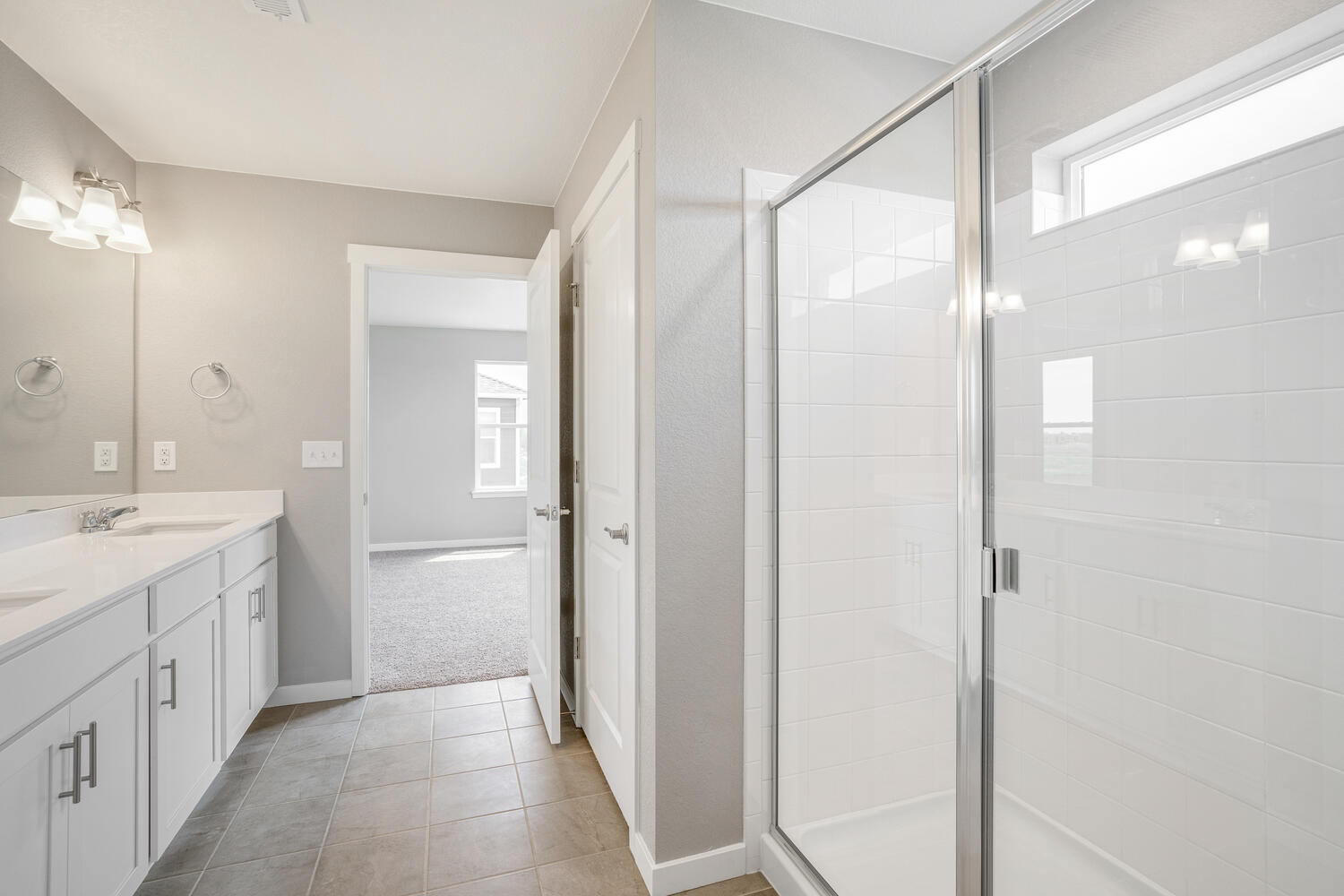 white cabinet bathroom with dual-basin sink, tile floor and shower