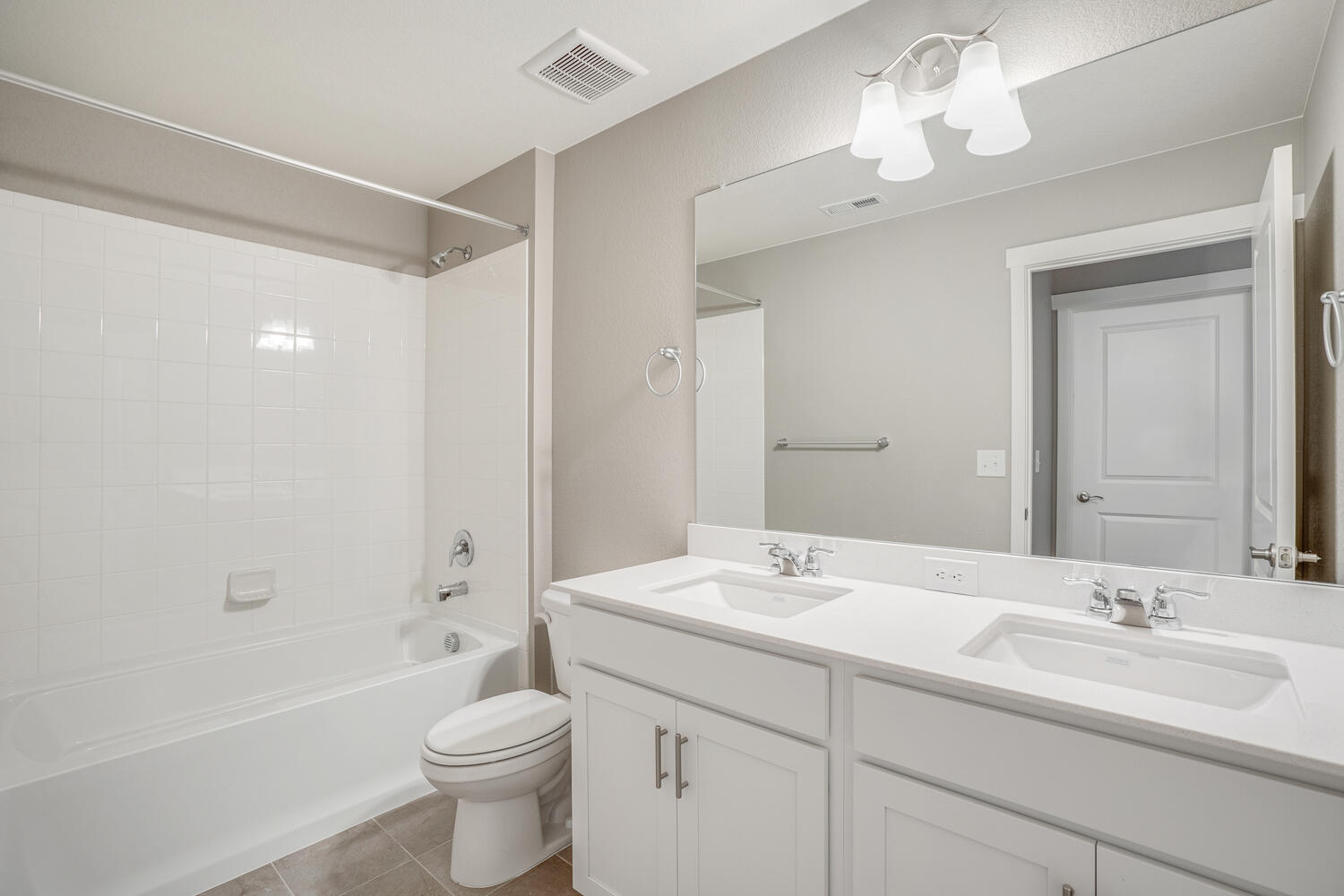 white cabinet bathroom with a tub and dual-basin sink