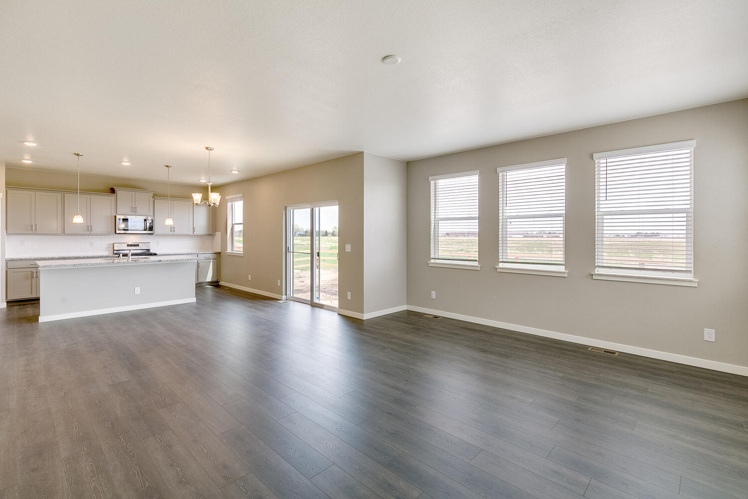 open space living room and kitchen with four windows