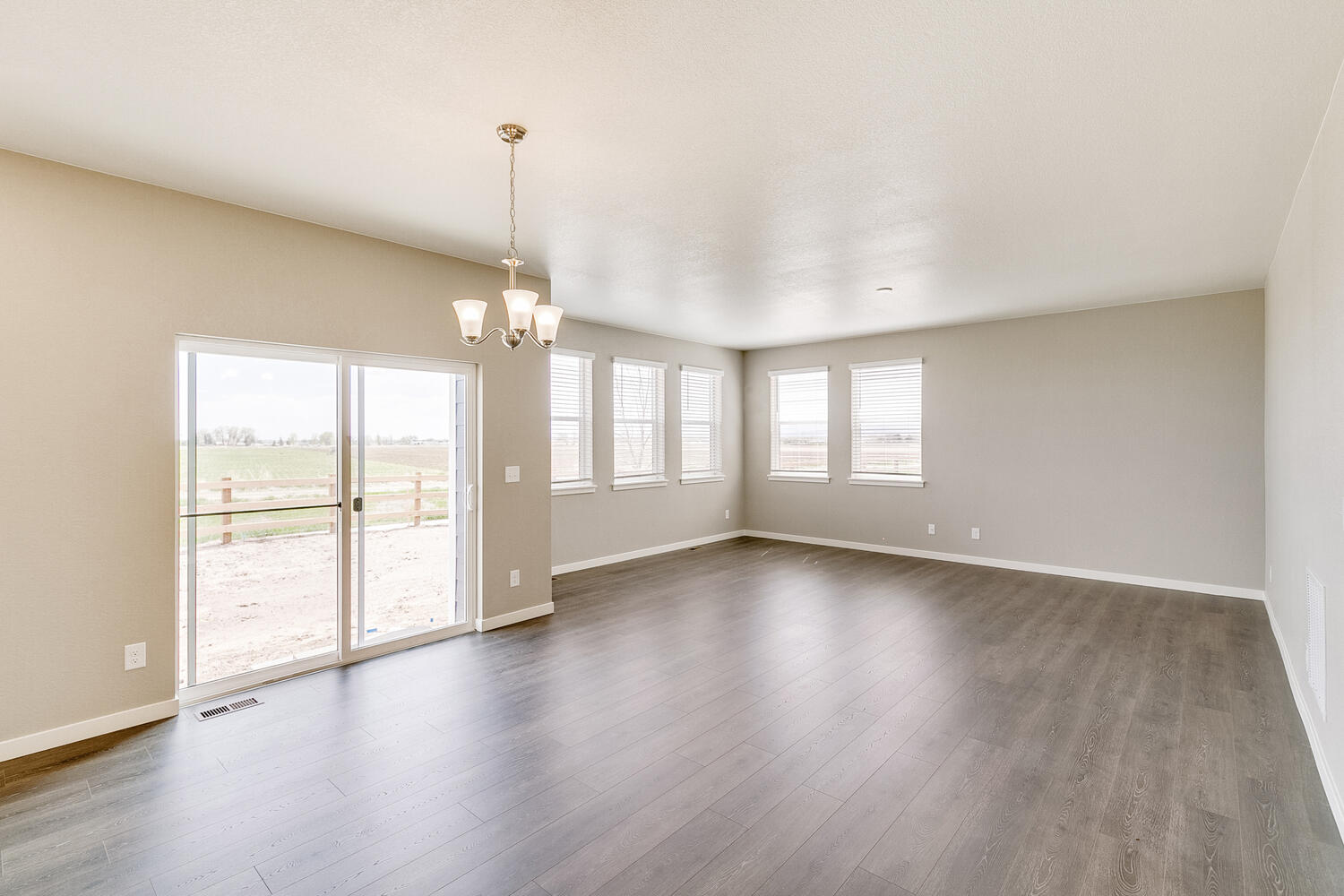 open space living room and kitchen with five windows