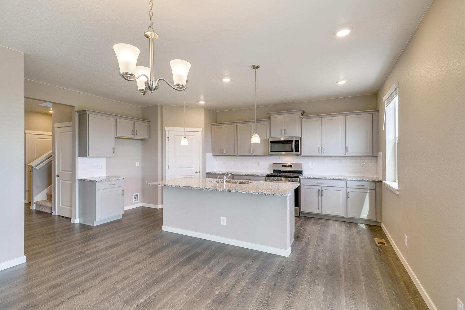 gray cabinet kitchen with stainless steel appliances, and an island