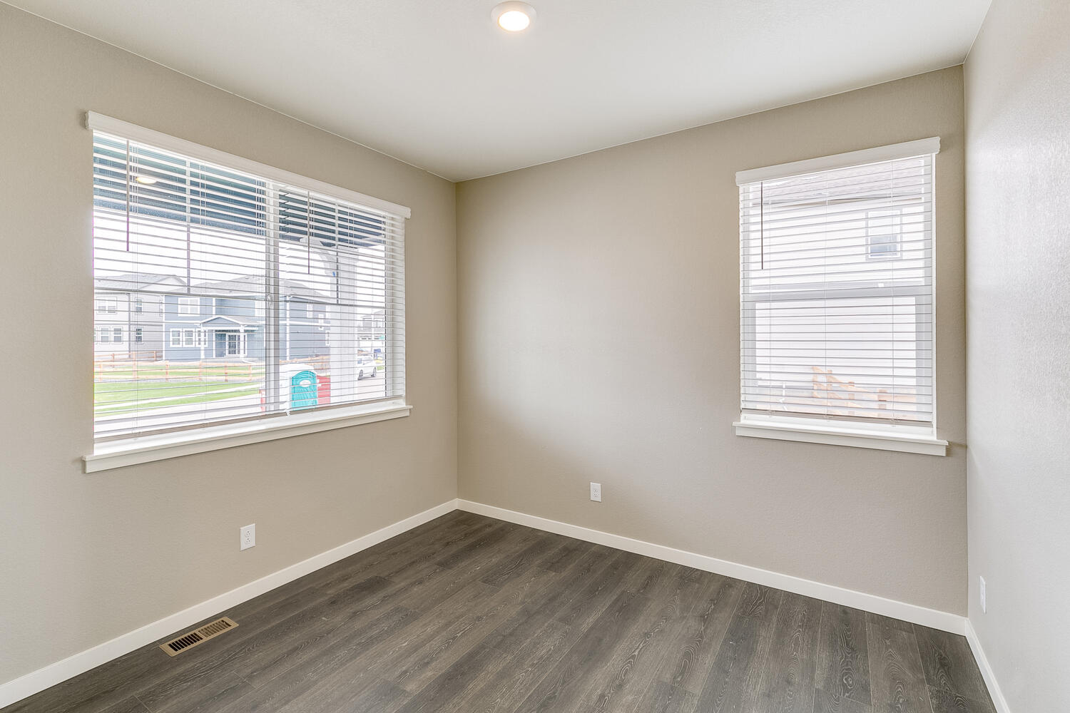 room with two windows and wood floor