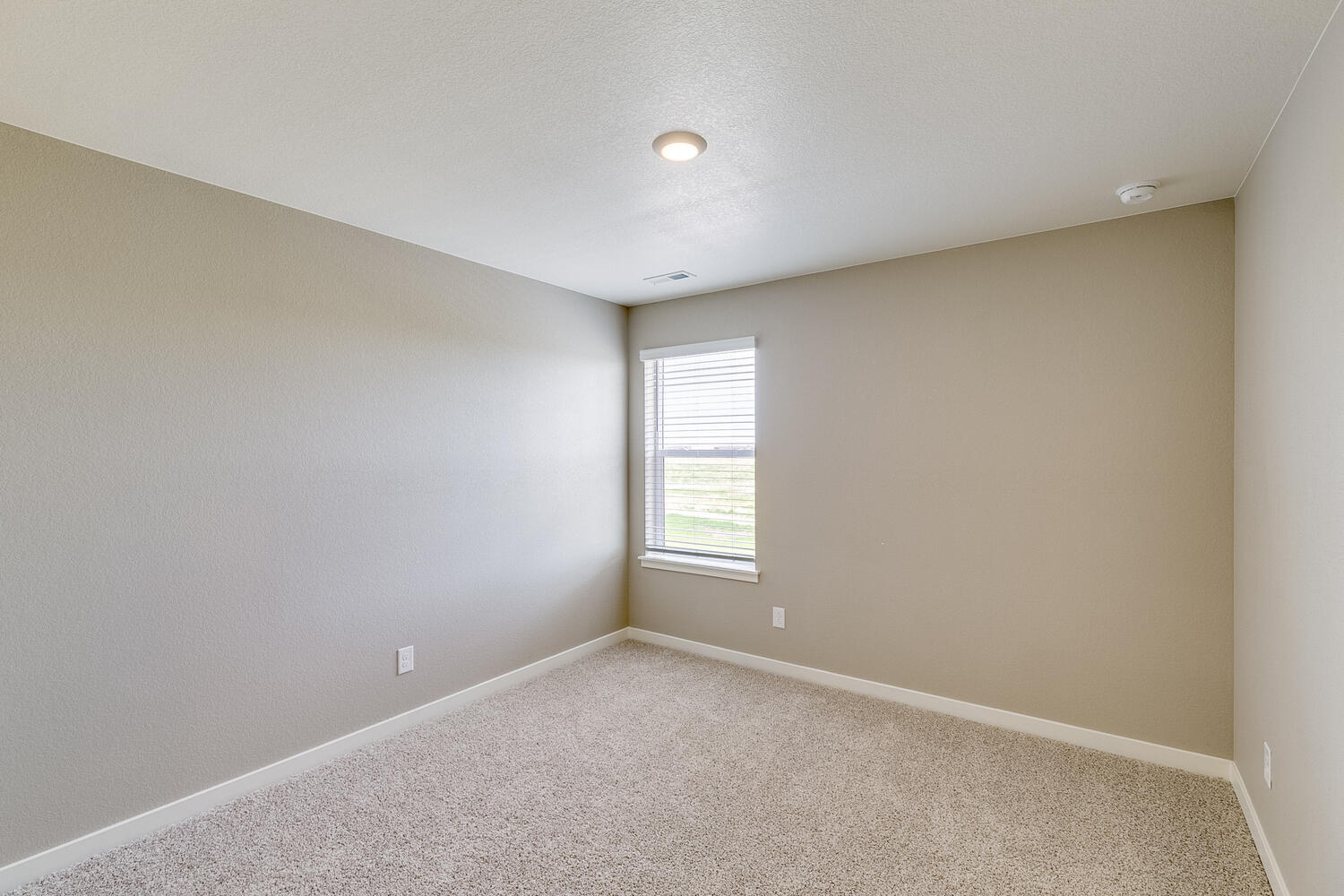 bedroom with a window and carpet floor