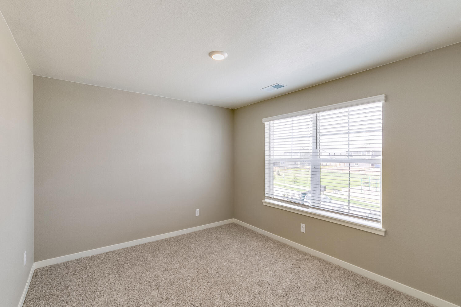 bedroom with a window and carpet floor