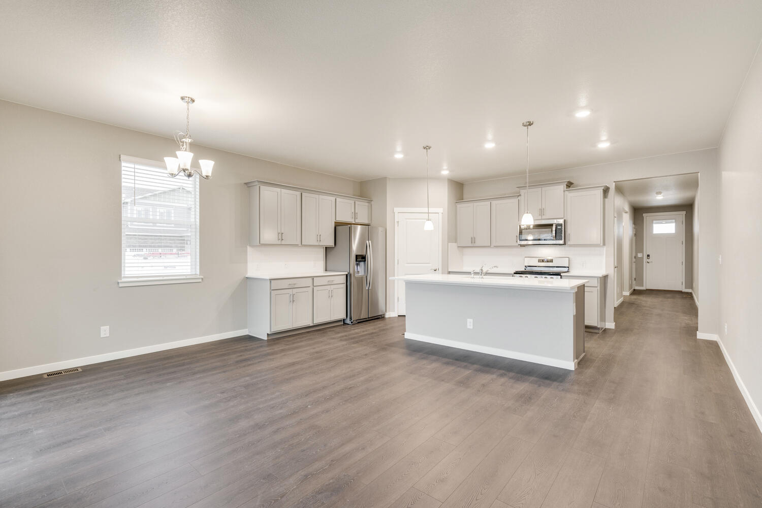 open space living room and kitchen with a window